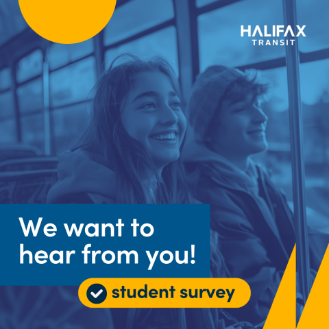Two students sitting on transit bus with smiles on their faces.